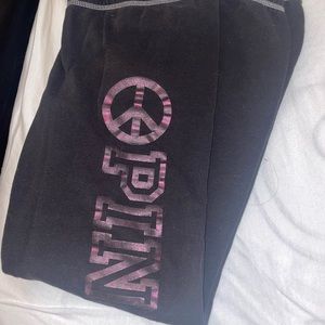Victoria Secret black sweatpants with a metallic pink 'Pink' logo